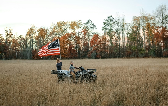 ATV in field with American flag