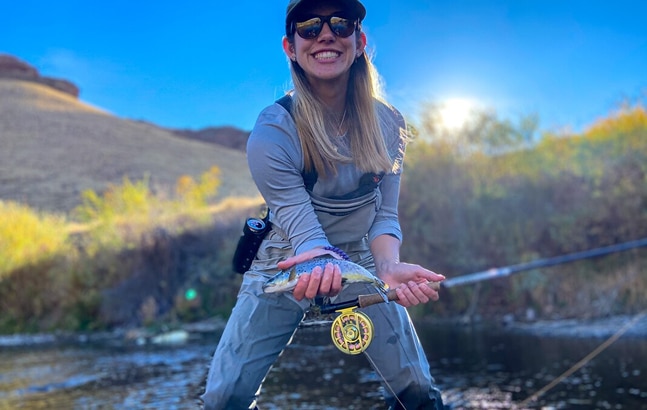 Female fisherman smiling with catch