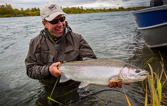 Fisherman smiling while holding a nice catch