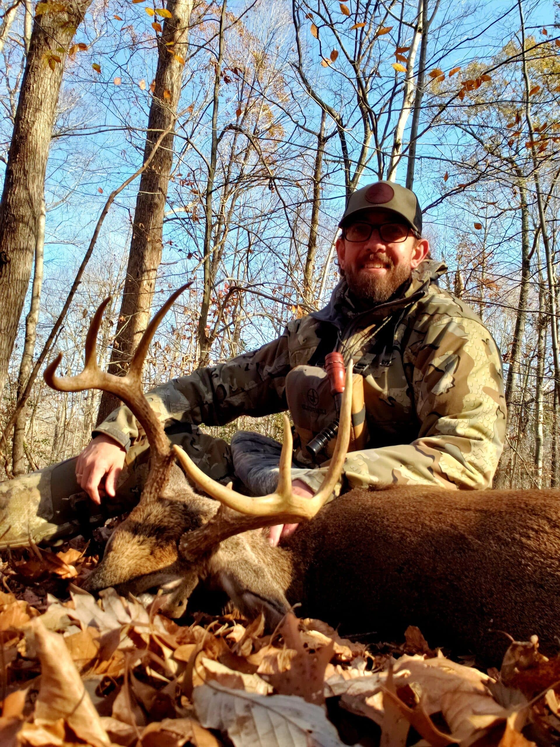 Hunter posing with deer with large antlers