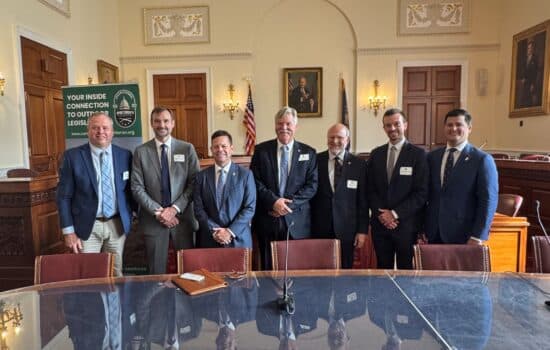 Group of lawmakers stand together in a row