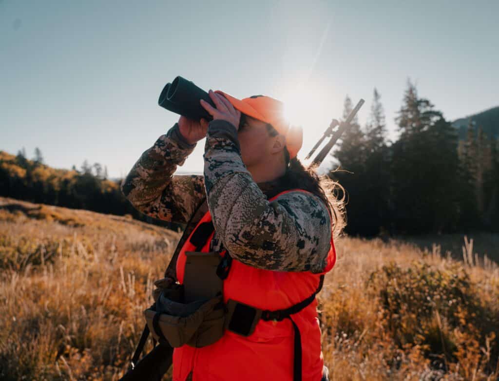 Sports woman looking through binoculars