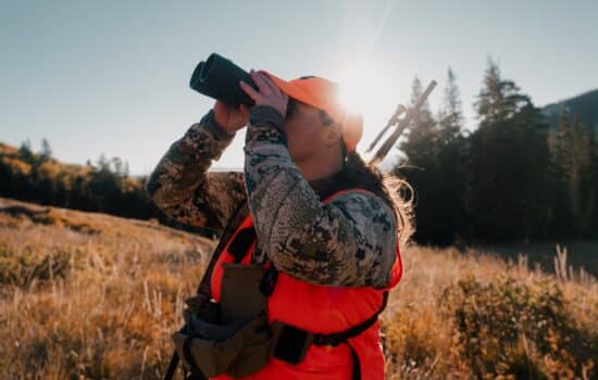 Sports woman looking through binoculars