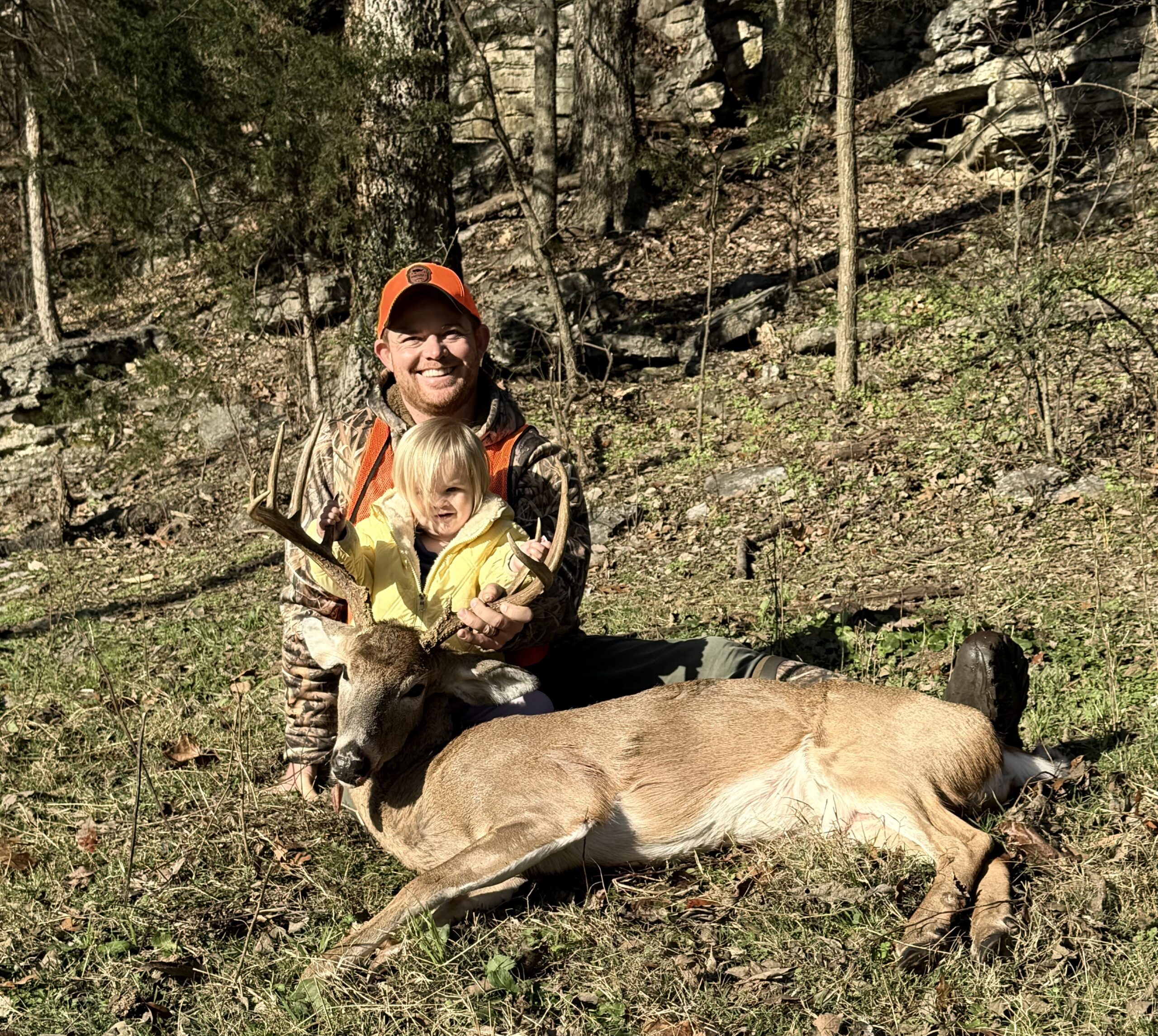 Hunter posing with buck