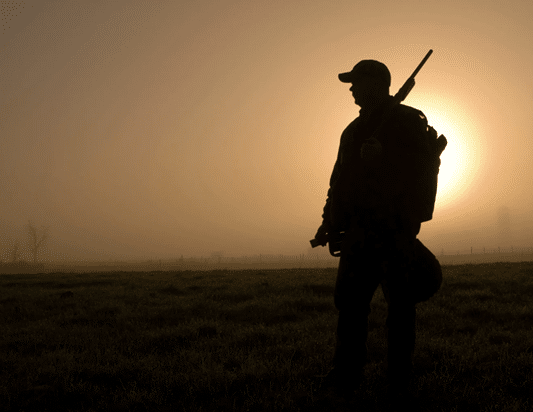 Silhouette of hunter at dawn