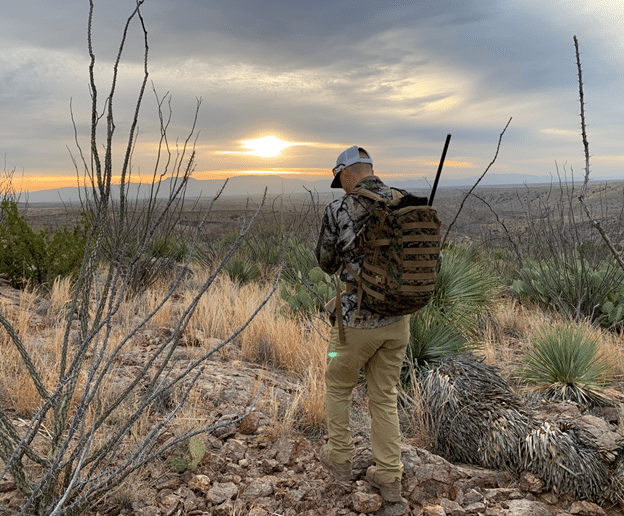 Hunter hiking at sunrise